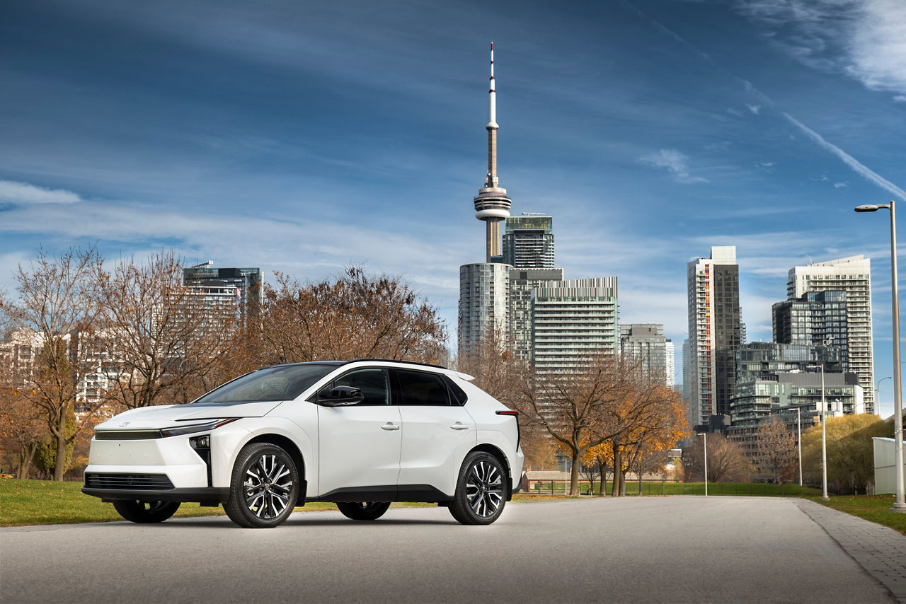 Official Toyota Canada image of a white 2026 Toyota bZ with the Toronto skyline behind it