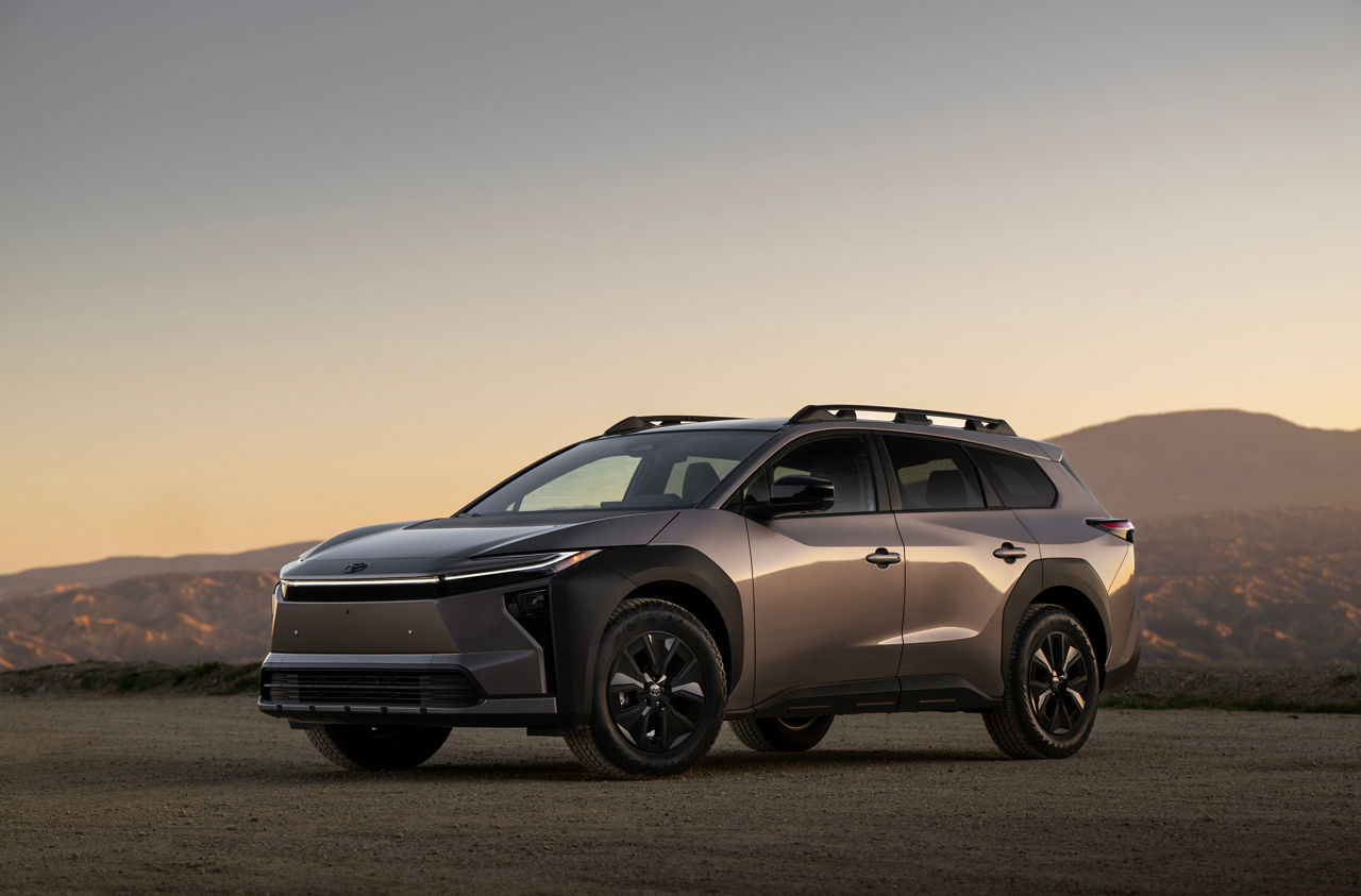 Official Toyota Canada image of a bronze 2026 bZ Woodland parked on a gravel overlook