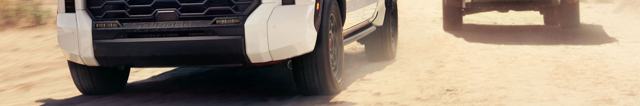 toyota-trucks-family-lineup-2025-tundra-hybrid-limited-trd-pro-white-1794-smoked-mesquite-brawn-and-brains-l